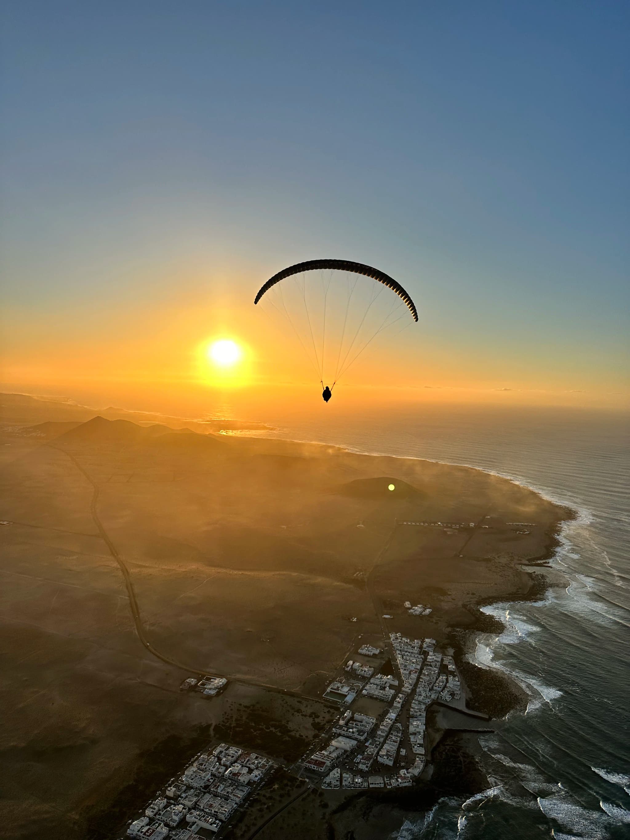 Sunset tandem paragliding over Famara