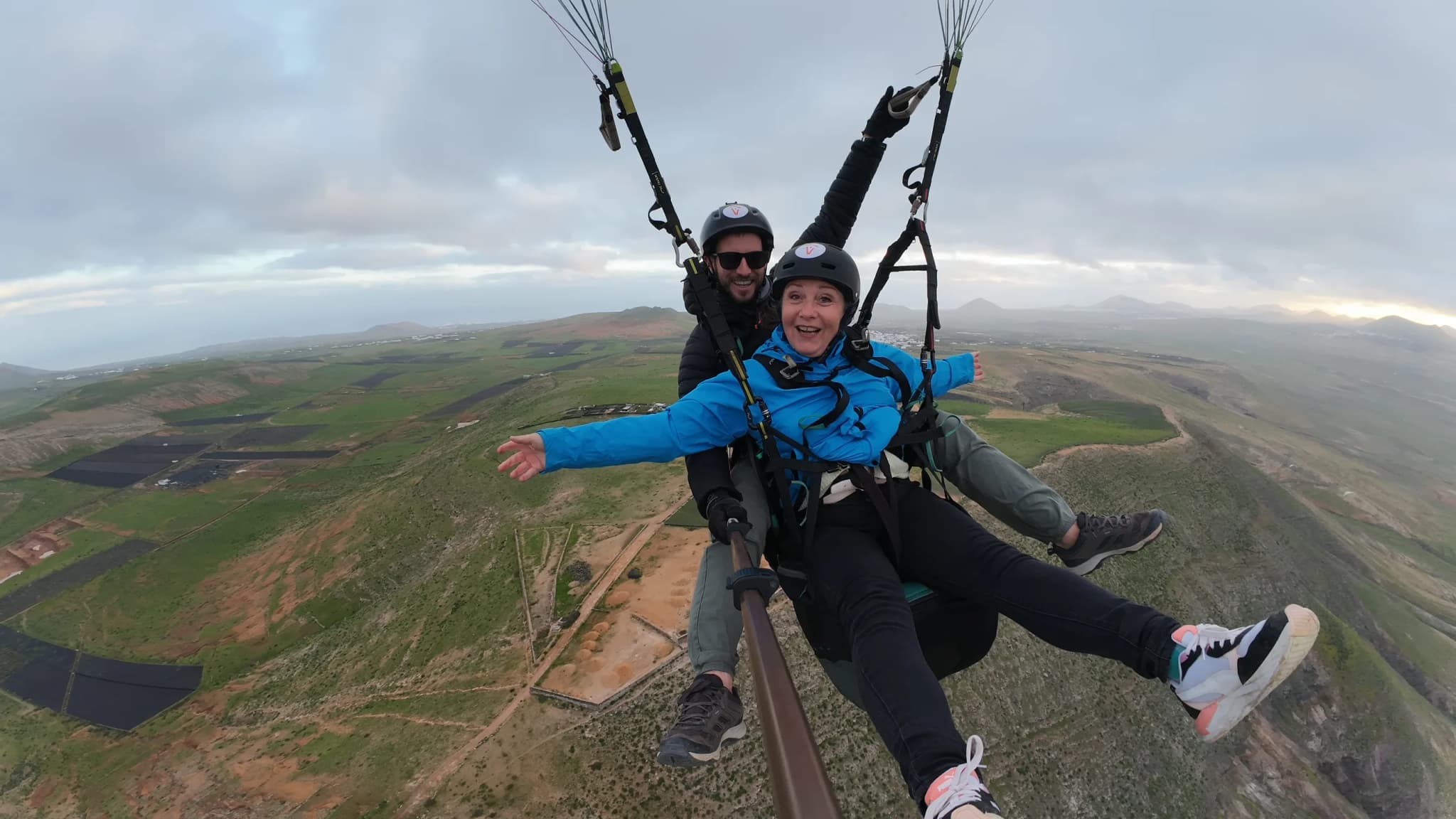 Joyful passenger with arms spread during tandem flight