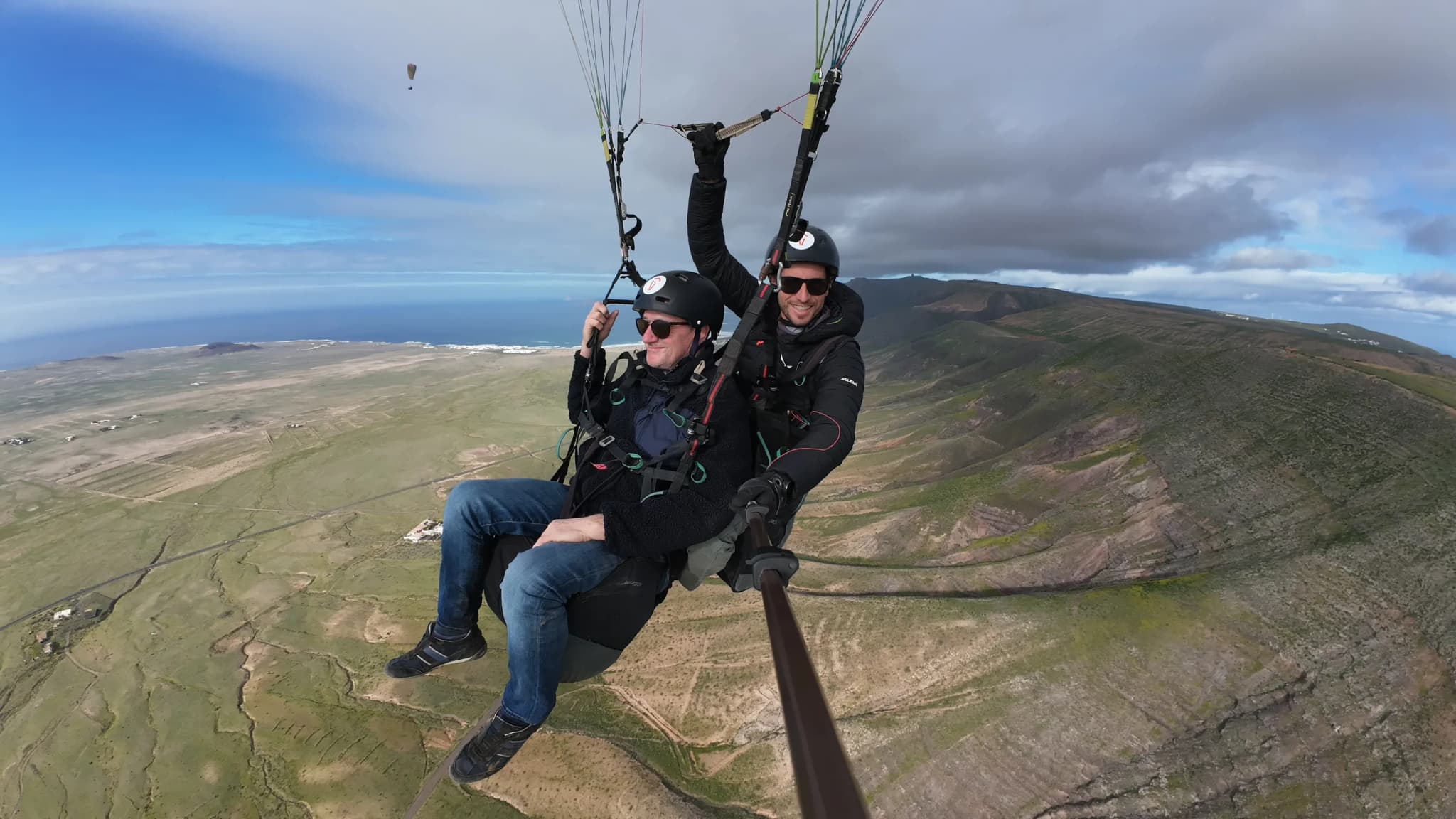 Tandem paragliding over Lanzarote volcanic panorama
